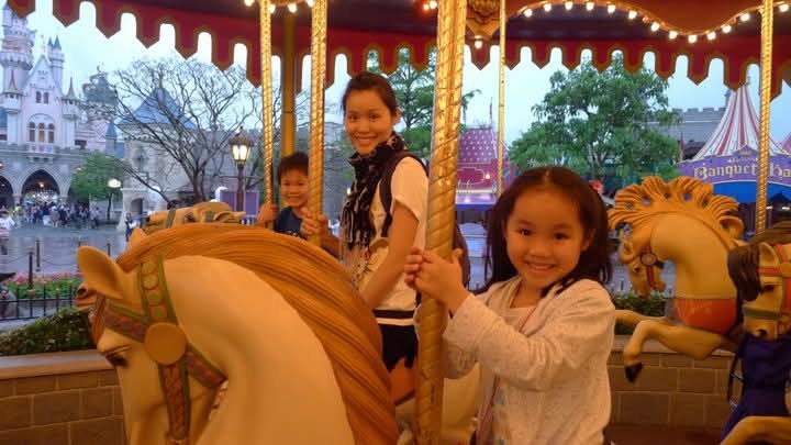 Chloe as a young child on the carousel at Hong Kong Disneyland